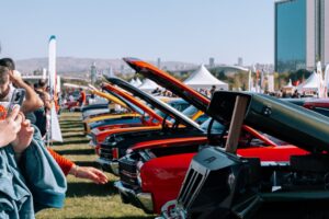 Row of Classic American Cars with Raised Hoods at the Car Show